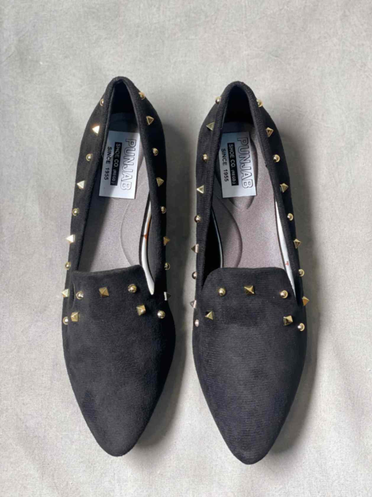Top view of black suede loafers with subtle detailing, perfect for casual or semi-formal occasions.