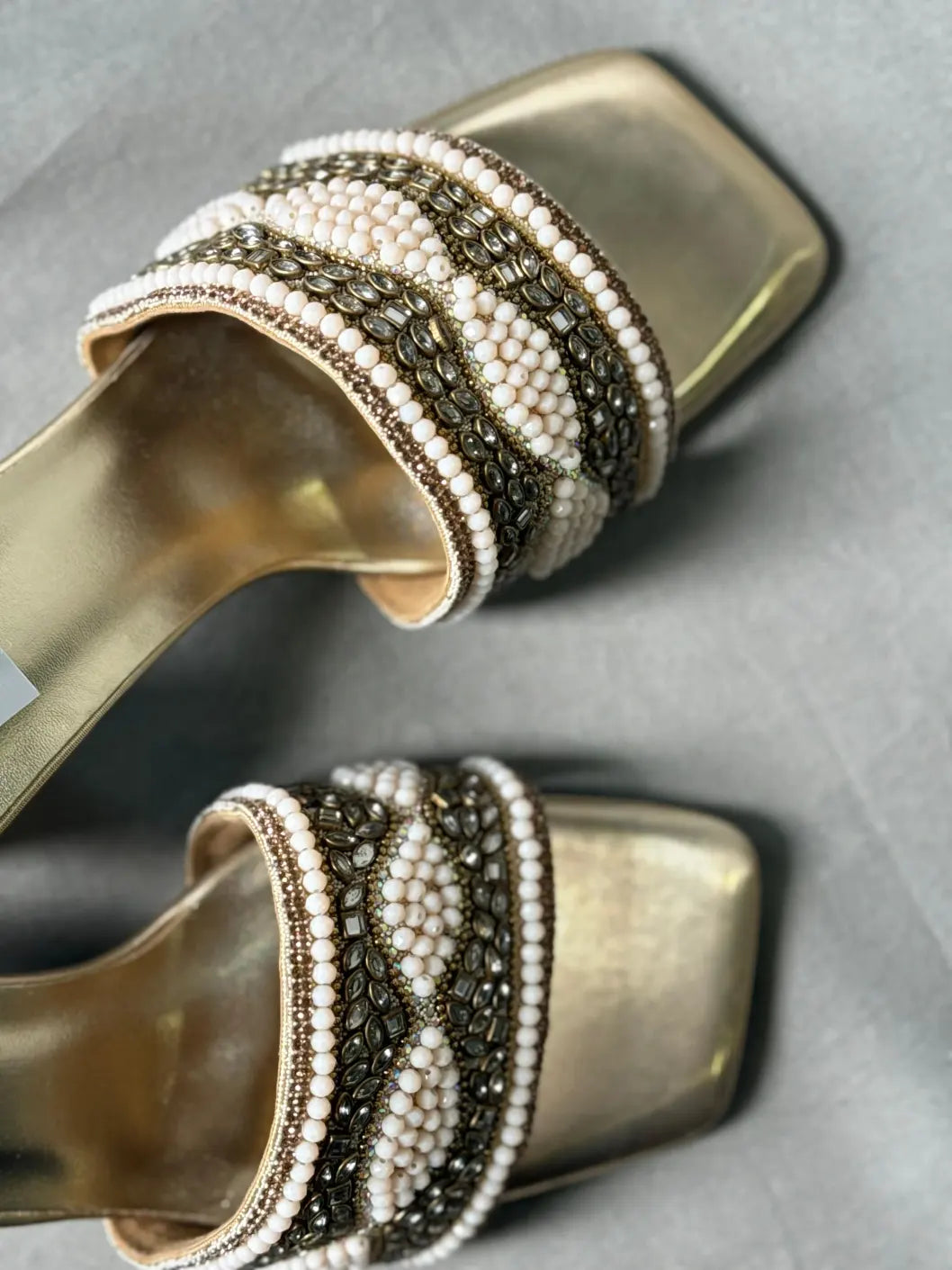 Close-up of Embellished Golden Mules with Sparkling Rhinestones