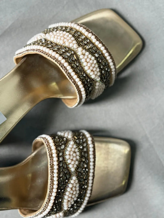 Close-up of Embellished Golden Mules with Sparkling Rhinestones