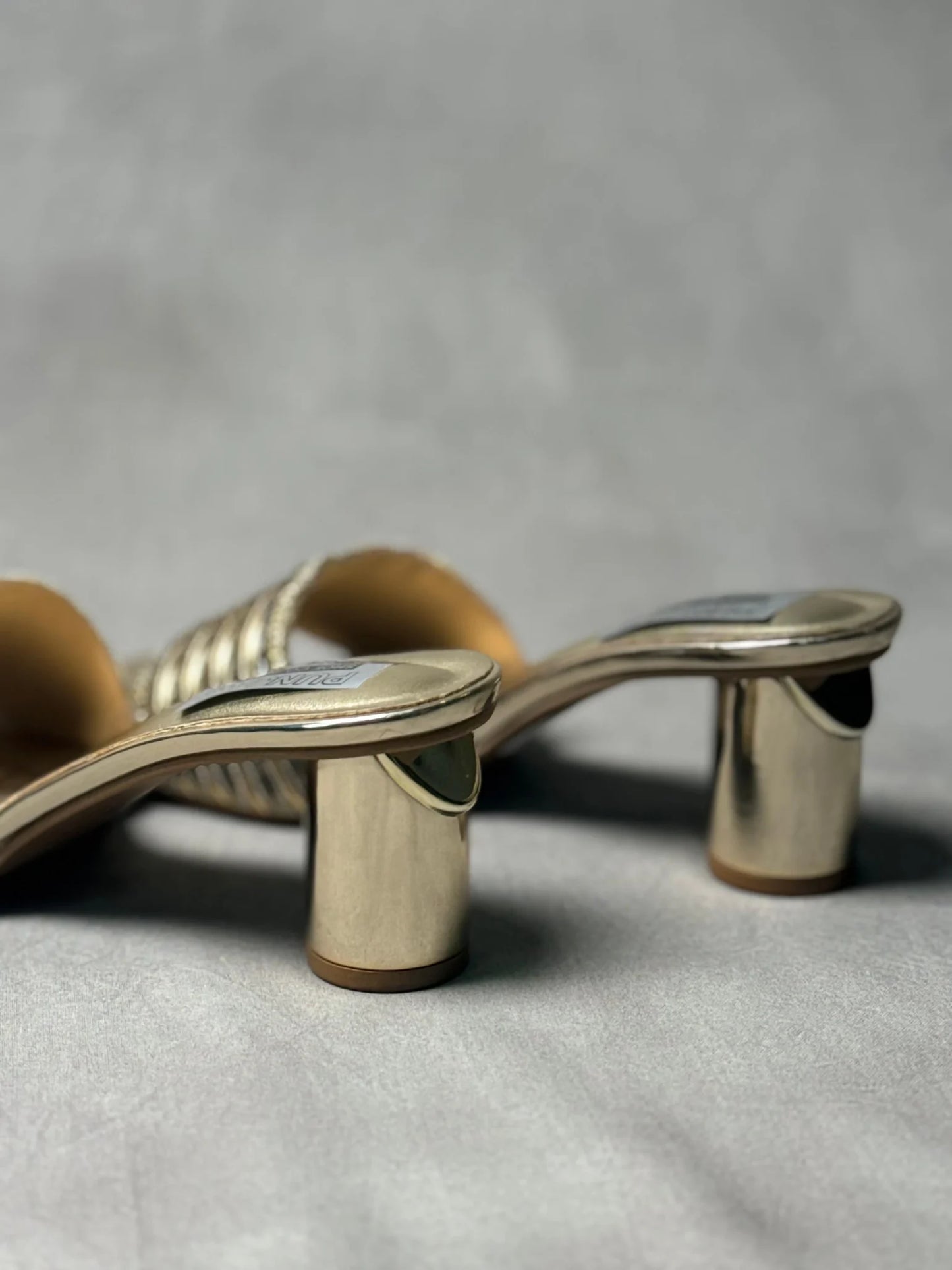 Rear view of Embellished Golden Metallic Mules, highlighting the luxurious golden metallic finish and embellishments.