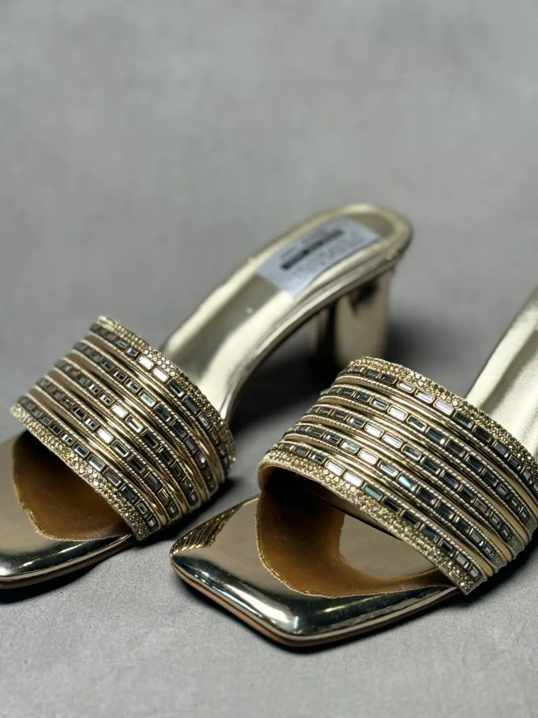 Close-up of Embellished Golden Metallic Mules with sparkling embellishments, ideal for special occasions.
