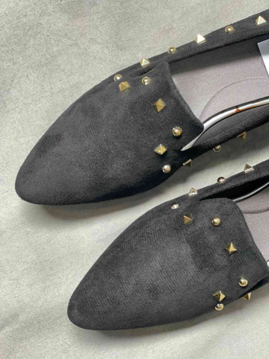 Close-up view of black suede loafers featuring a cushioned insole for all-day comfort