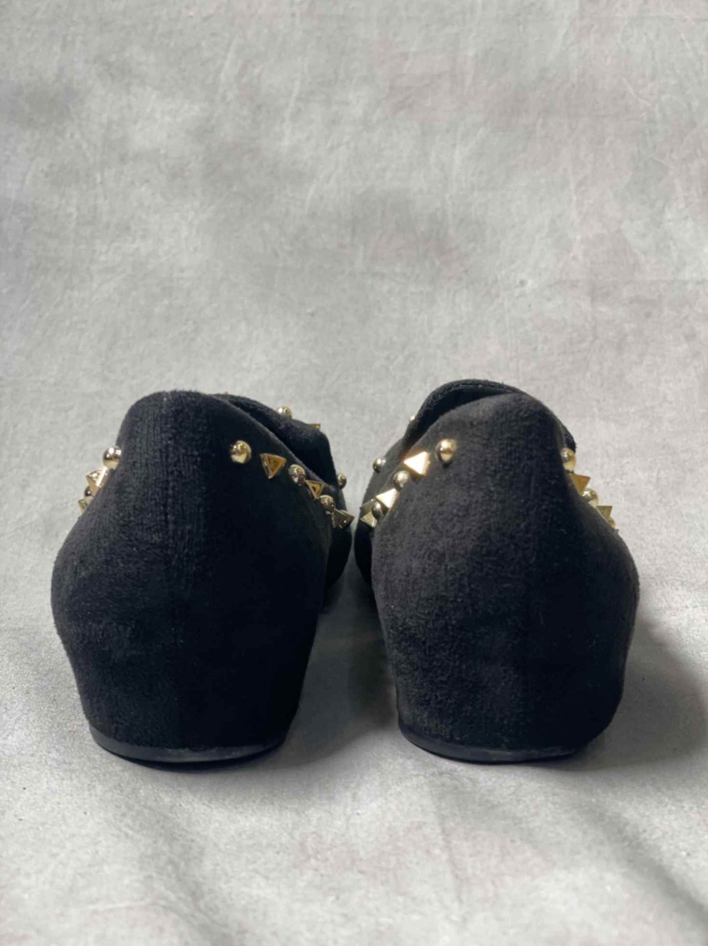 Back view of black suede loafers, highlighting the clean, streamlined design and durable rubber outsole for superior traction.