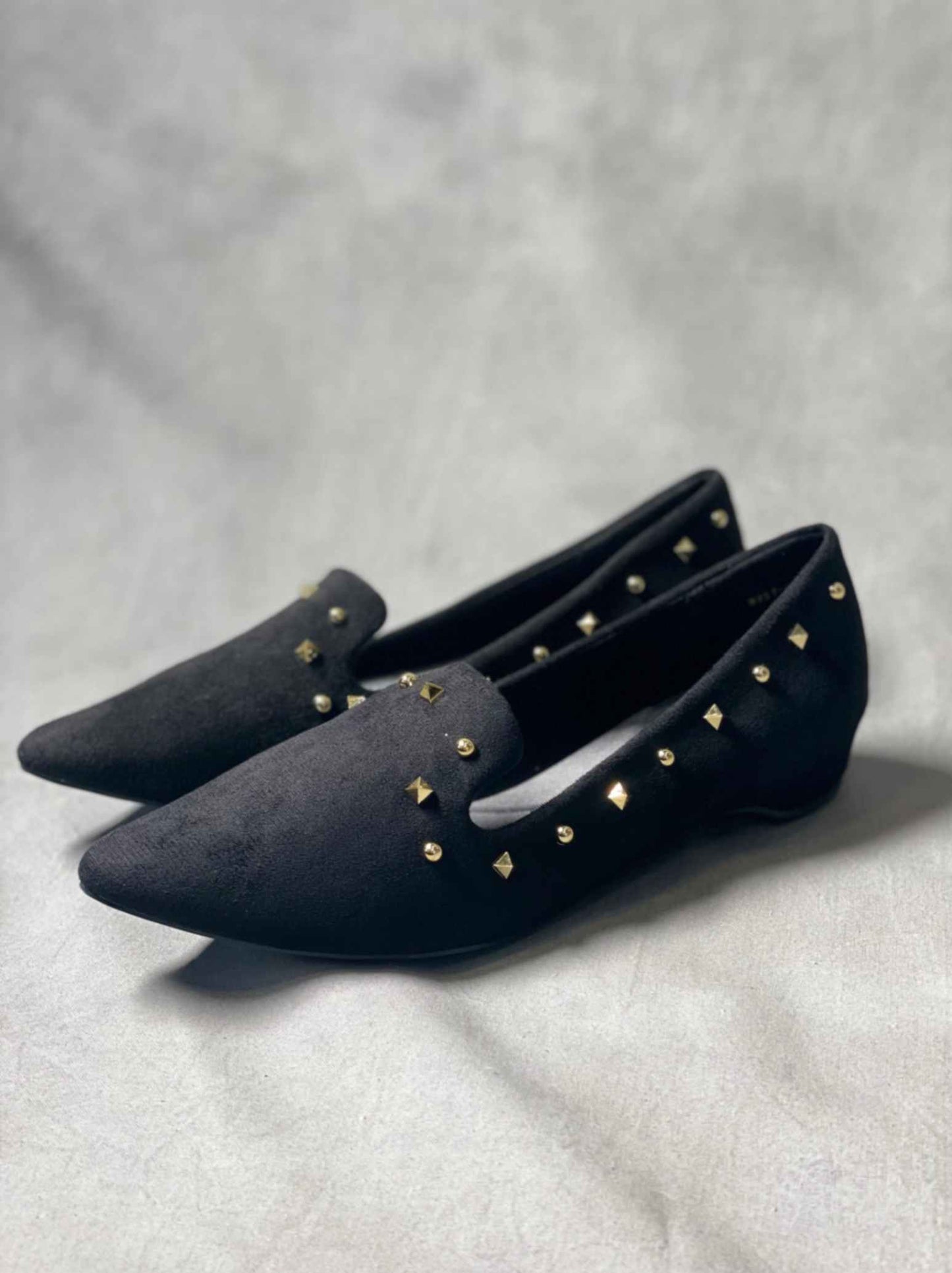 Side view of black suede loafers showcasing a refined, timeless design with durable rubber outsole.
