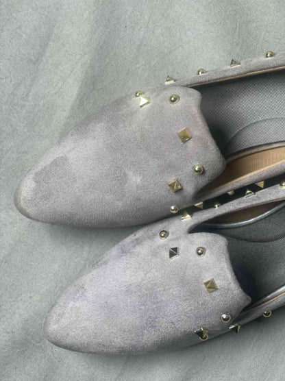 Close-up of grey suede loafers for women, featuring a soft, luxurious texture and elegant silhouette.