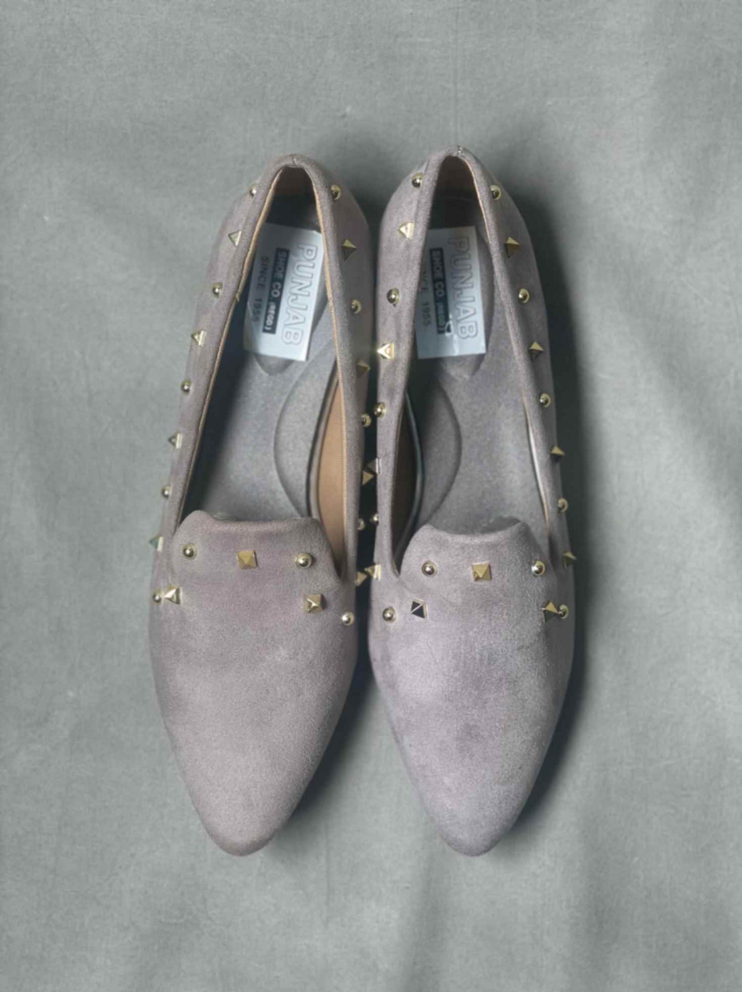 Top view of grey suede loafers for women, highlighting their versatile and timeless style.